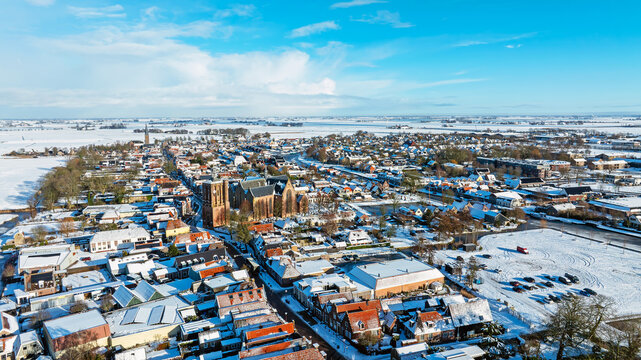 Aerial View of Snowy Historic Town with Church in Winter