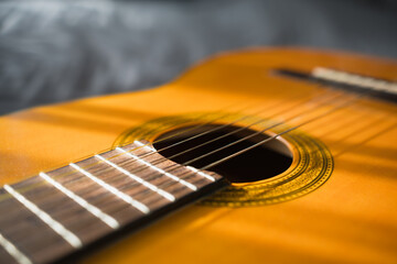 Fototapeta premium Guitar Body And Strings In Sunlight. Acoustic Musical Instrument. Music Background. Shallow Depth Of Field