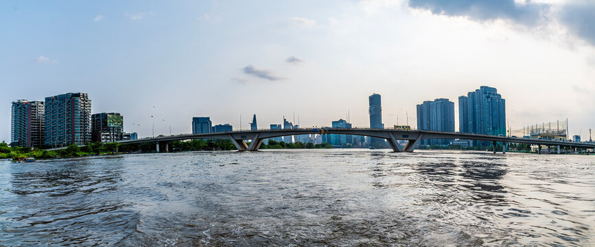 A panorama view past the Thu Thiem Bridge on the Saigon River in Ho Chi Minh City. Vietnam on bright spring day