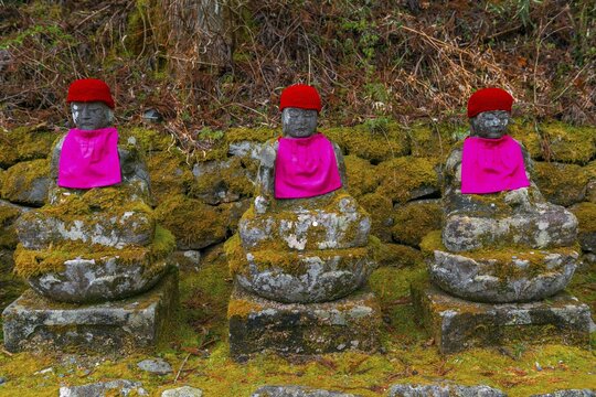 Jizo statues with red caps, protective deities for deceased children, Kanmangafuchi Abyss, Nikko, Japan