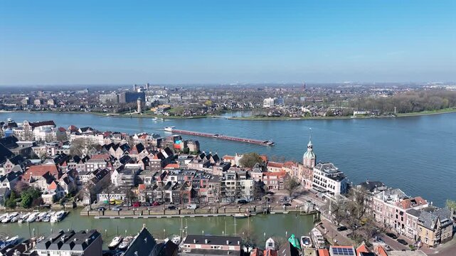 River shipping near a historic riverside city in Europe