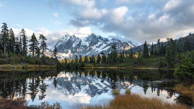 Mt. Shuksan Glacier with snow with reflection in Picture Lake, forested mountain landscape, Mt. Baker-Snoqualmie National Forest, Washington, USA