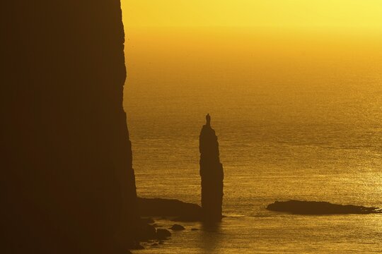 Kellingin sea stack, petrified troll according to legend, at sunset, Ei&eth;i, Eysturoy, Faroe Islands, Denmark