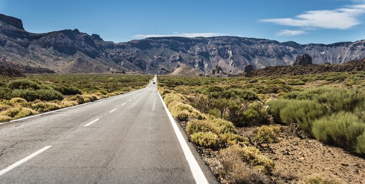 Road through volcanic landscape, plateau Llano de Ucanca with shrubs, Parque Nacional de las Ca&ntilde;adas del Teide, Teide National Park, UNESCO World Heritage Site, Tenerife, Canary Islands, Spain