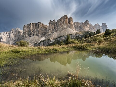 Sella Group with Piscadu reflected in a pond, Gardena Pass, Passo Gardena, nature park Park Puez Iceman, Dolomites, Selva di Val Gardena, South Tyrol, Trentino-Alto Adige, Italy