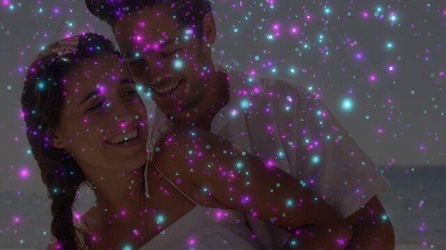 Couple embracing on shore, sparkle overlay growing denser, leaning and sharing look for marketing