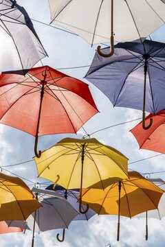 Many colorful umbrellas, sunshades, hanging in the air, sunshine, Imst, Tyrol, Austria