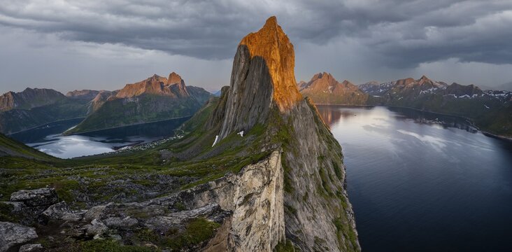 Dramatic clouds, evening mood, steep mountain Segla, fjord Mefjords with mountains, island Senja, Troms, Norway