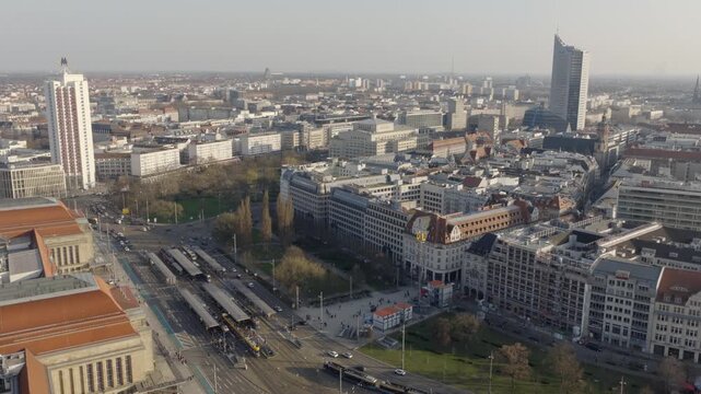 Extensive aerial view of the city of Leipzig in daylight, showing the urban center and dense development from a bird's-eye perspective.