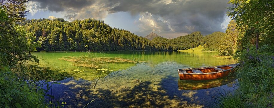 Idyllic Lake Alatsee with rowing boat, F&uuml;ssen, Bavaria, Germany