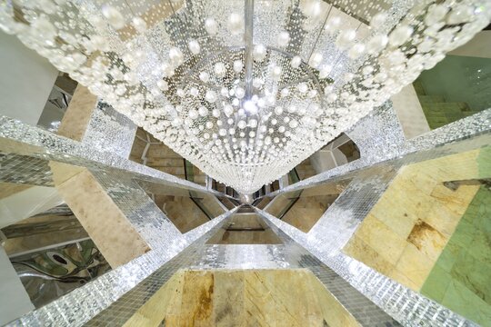 Huge lamp decorated with glass beads in the stairwell, main chedi (Phra That), Buddhist temple complex Wat Phra That Sorn Kaew, Khao Kho mountains, Phetchabun province, Isan, Thailand