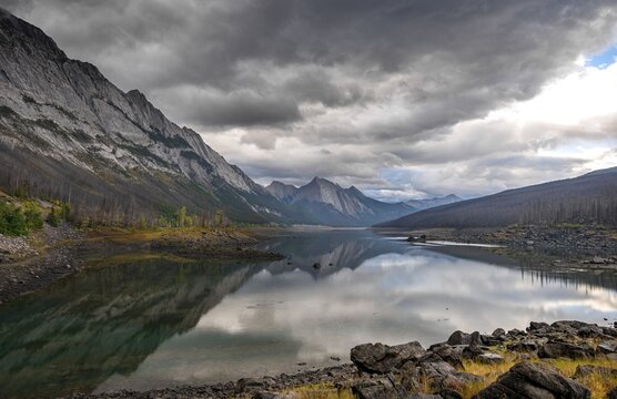 Mountains reflected in a lake, Medicine Lake, Maligne Valley, Jasper National Park, Alberta, Canada