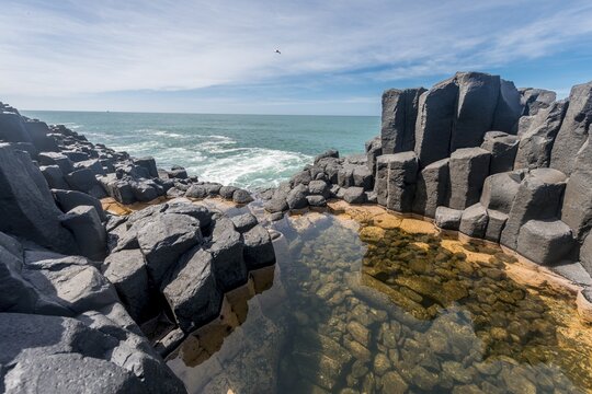 Water gathering between rocks, Roman Bath, Hexagonal basalt column by the Sea, Blackhead, Dunedin, Otago, South Island, New Zealand