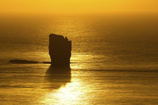 Risin sea stack, petrified troll according to legend, at sunset, Ei&eth;i, Eysturoy, Faroe Islands, Denmark
