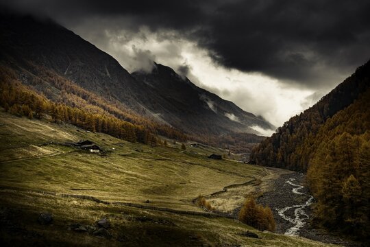 Alpine hut in autumnal mountain landscape with threatening cloudy sky, Pfossental, Merano, Vinschgau, South Tyrol, Italy