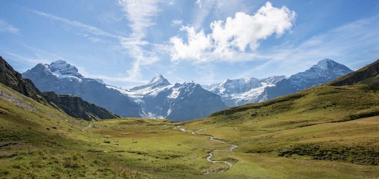 River meanders, behind snow-covered Schreckhorn, Wetterhorn and Eiger, Grindelwald, Bern, Switzerland