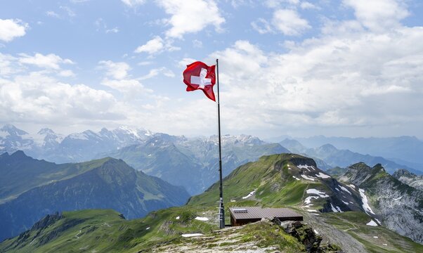 Swiss national flag at the summit of Faulhorn, mountain panorama, Bernese Alps, Bernese Oberland, Switzerland