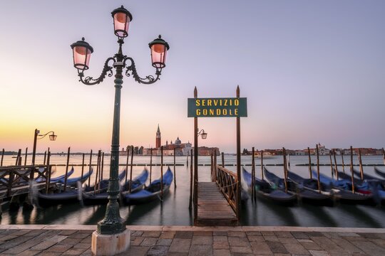 Boat landing stage, Servicio Gondole, jetty with Venetian gondolas, in the back church San Giorgio Maggiore, long exposure, dawn, Venice, Veneto, Italy