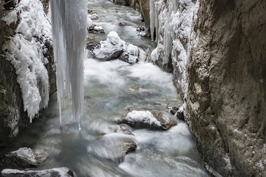 Wild river Partnach in the Partnachklamm with long icicles and snow in winter, near Garmisch-Partenkirchen, Upper Bavaria, Bavaria, Germany