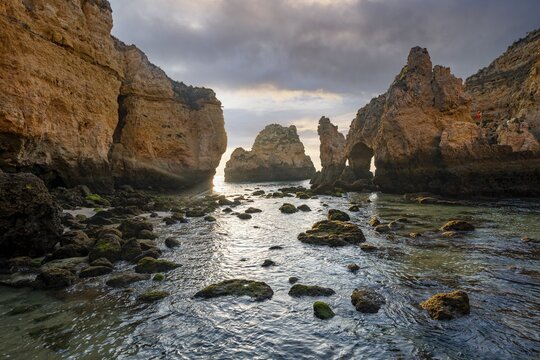 Rock formations in the sea, morning light, sandstone cliff, cloudy atmosphere, Ponta da Piedade, Algarve, Lagos, Portugal