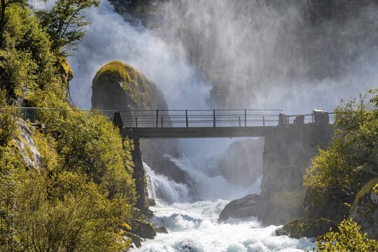 River Briksdalselva, Hike to the Briksdalsbreen, Bridge at the waterfall Kleivafossen, Briksdal, Norway