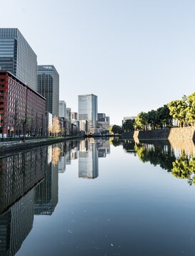 High-rise buildings reflected in a canal, downtown Toyko, at Kokyo Gaien National Garden, Chiyoda-ku, Tokyo, Japan