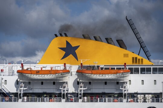 Black smoke rising from the exhaust pipes of a ferry, Syros, Cyclades, Greece