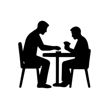 Two men playing cards at a table silhouette