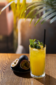 Fresh tropical drink with passion fruit and mint served in a restaurant with natural light in the afternoon