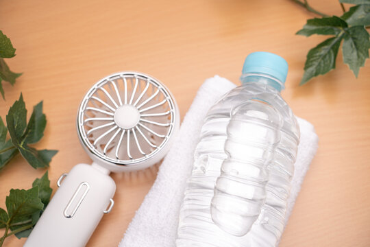 Personal cooling items with fan towel and water for hot weather