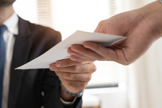 Close up view of office worker receiving salary from boss.