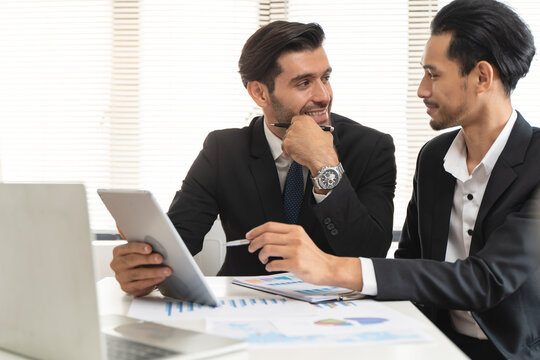financial advisory services. Asian advisor showing plan of investment to clients in the consultancy office.