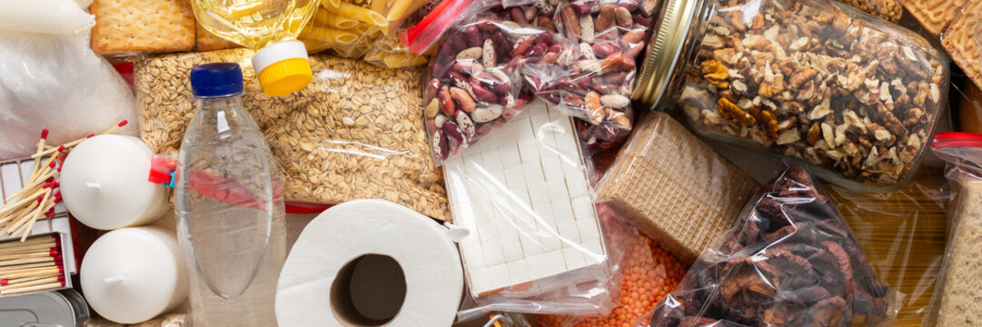 Essential home food stock for military operations and crises and for the period of quarantine and isolation, canned food, pasta, flour and nonperishable items,the concept of stay at home, banner