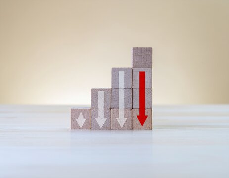 Burnout and Performance Drop Concept with Wooden Blocks and Red Arrow