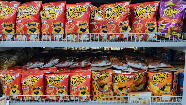 Cheetos snacks displayed on supermarket shelf with colorful packaging