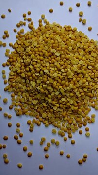 Pouring Toor Dal Grains on White Background