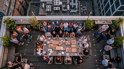 Obraz premium Large group sharing meal on rooftop terrace at dusk