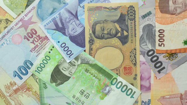 World international banknotes rotating footage. Chinese Yuan, Korean Won, Indonesian Rupiah, Turkish Lira, Japanese Yen, Kyrgyz Som. Business currency finance background