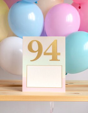Birthday card with number 94 and text box for name or message. Pastel colors and balloons