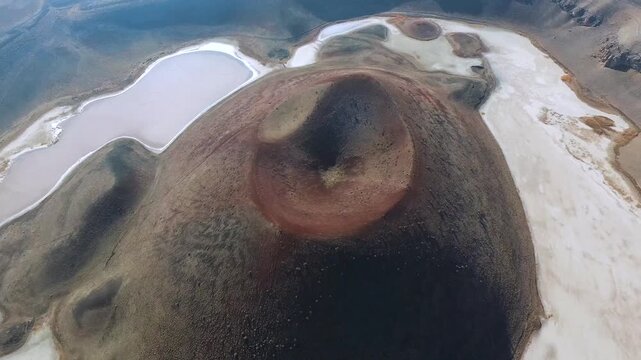 Aerial view of tuff ring cone and volcanic crater lake maar in a barren caldera of Konya Turkiye. Rocky terrain, topography, wilderness, anatolia depict rugged regional geology natural history.