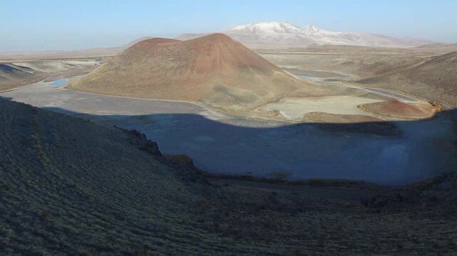 Aerial view of tuff ring cone and volcanic crater lake maar in a barren caldera of Konya Turkiye. Rocky terrain, topography, wilderness, anatolia depict rugged regional geology natural history.