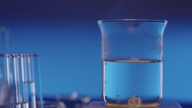 Liquid Boiling in Glass Beaker on Magnetic Hot Plate Stirrer, dolly shot (High frame rate 120fps)