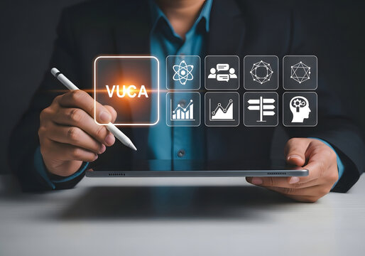 Businessman using a digital tablet with vuca and strategy icons for business planning and analysis