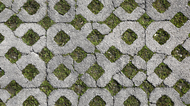 Permeable concrete pavers creating an eco friendly urban surface, interlocking patterns of gray stone and green grass for drainage and sustainable design