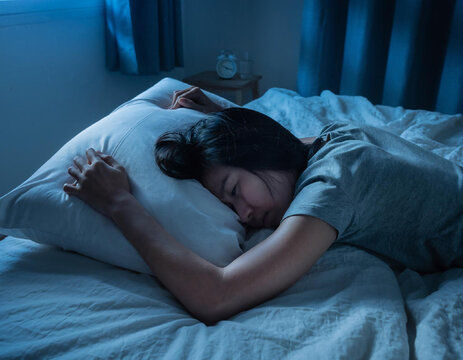 Woman sleeping peacefully on bed.