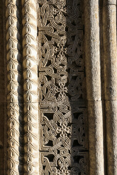 Ornate seljuk stone carving on the divrigi great mosque and hospital facade, featuring deeply carved geometric patterns and floral motifs in weathered medieval relief