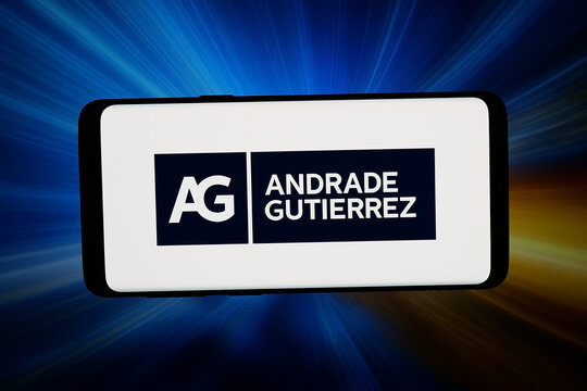 Stuttgart, Germany - 04-09-2026: In this photo illustration, the logo of Brazilian company Andrade Gutierrez S.A. is displayed on a smartphone in front of abstract background on computer screen.