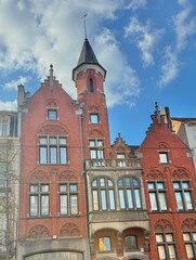 Obraz premium Stunning Neo-Gothic Red Brick Architecture with Ornate Turret and Spire