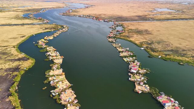 Aerial drone view of the floating Uros Islands on Lake Titicaca. The highest navigable lake in the world, located near Puno, Peru, South America. Popular travel destination.	