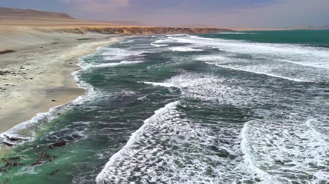 Aerial drone view of the Pacific Ocean and cliffs in Paracas. Dramatic Pacific landscape. Panoramic coastal view. Peru. Region Ica.	